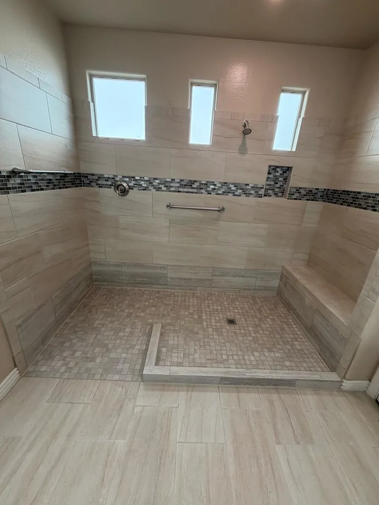 Walk-in tile shower with a low curb, a built-in bench and a grab bar by RDC Renovation, serving Surprise AZ