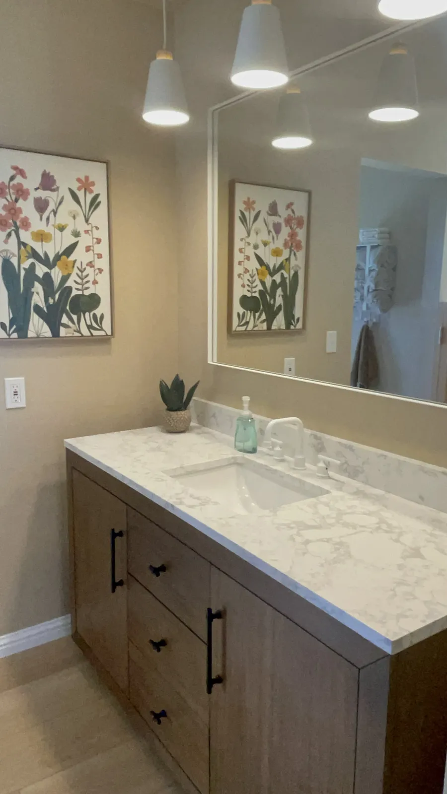 Remodeled bathroom vanity with marble look countertop and new fixtures in Phoenix AZ by RDC Renovation