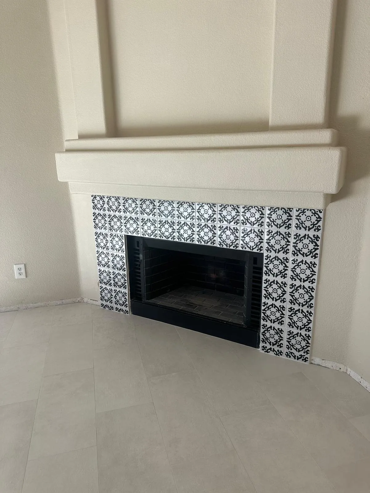 Black and white patterned tile fireplace surround with large format floor tile Phoenix AZ