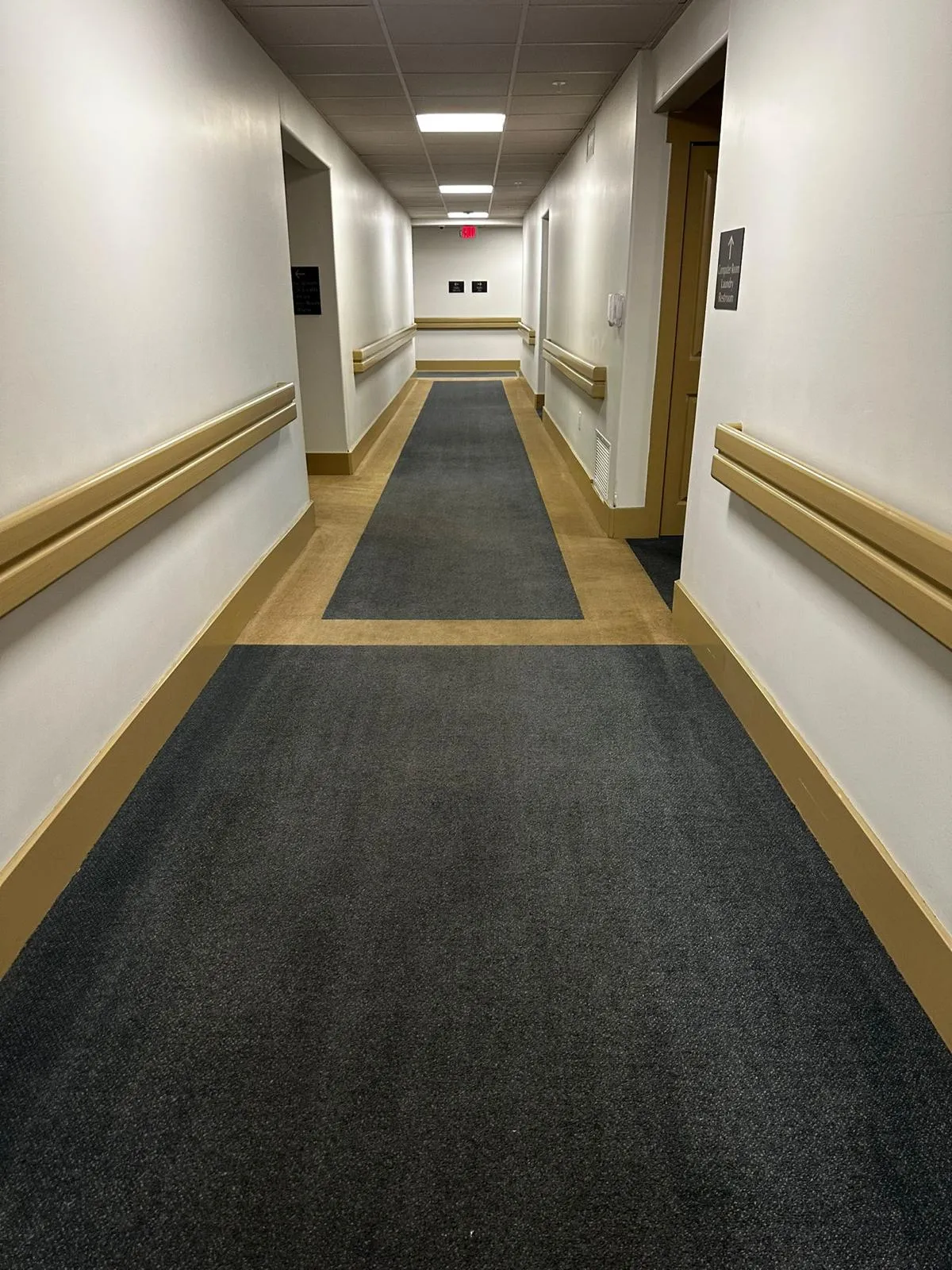 Commercial carpet installed in a facility corridor with handrails by RDC Renovation in Phoenix AZ