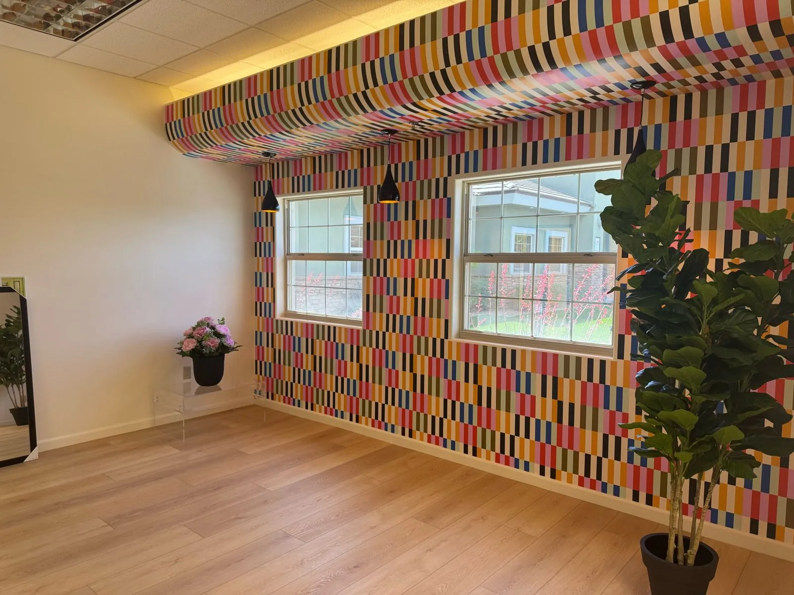 Commercial LVP flooring installation in modern office space with designer accent wall Phoenix AZ by RDC Renovation