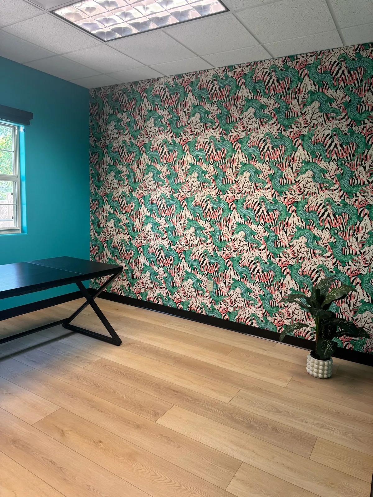 Commercial office with a teal accent wall and wood-look flooring installed by RDC Renovation in Phoenix AZ