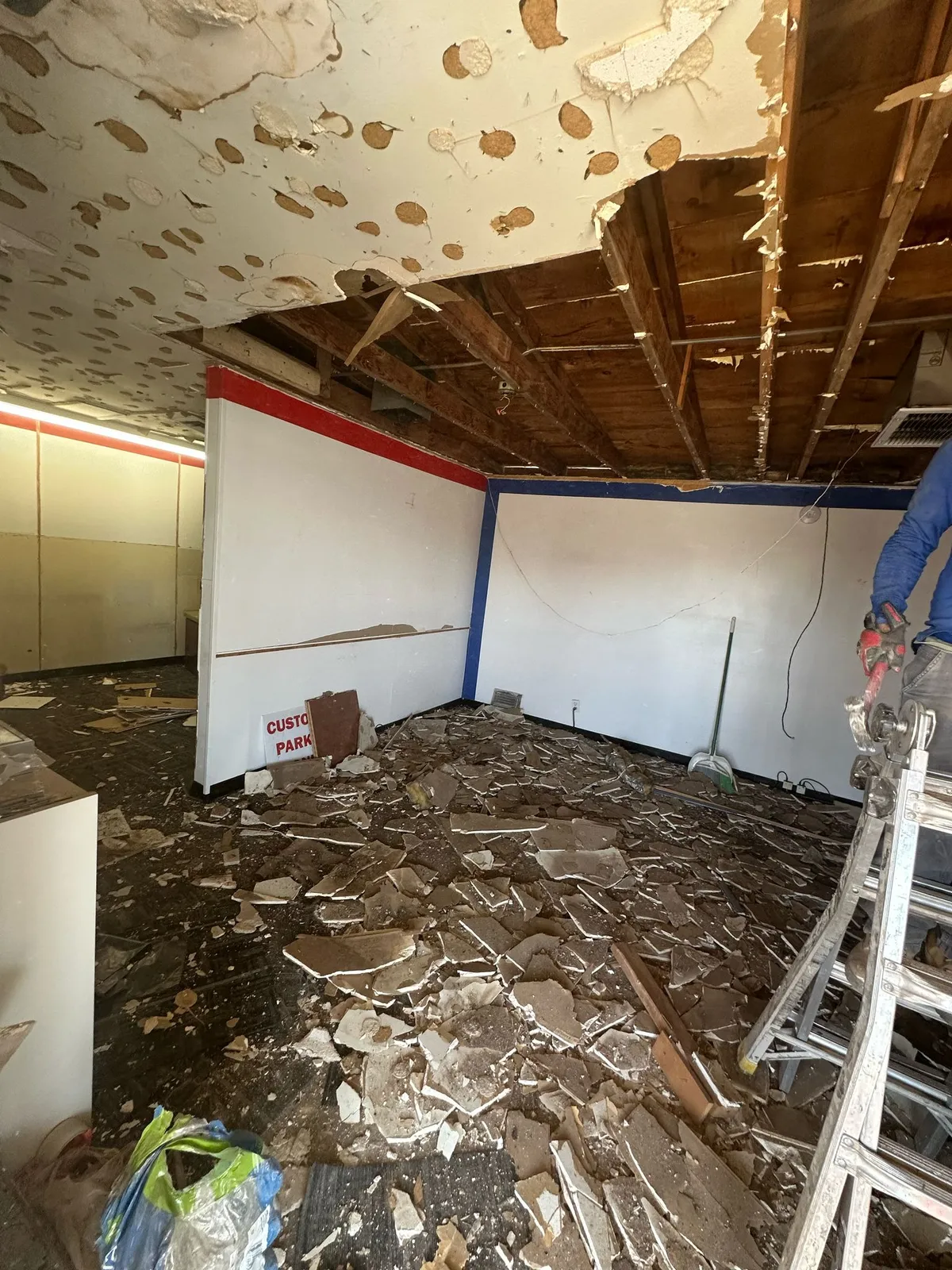 Commercial tenant improvement demolition with ceiling removed before new flooring by RDC Renovation in Phoenix AZ