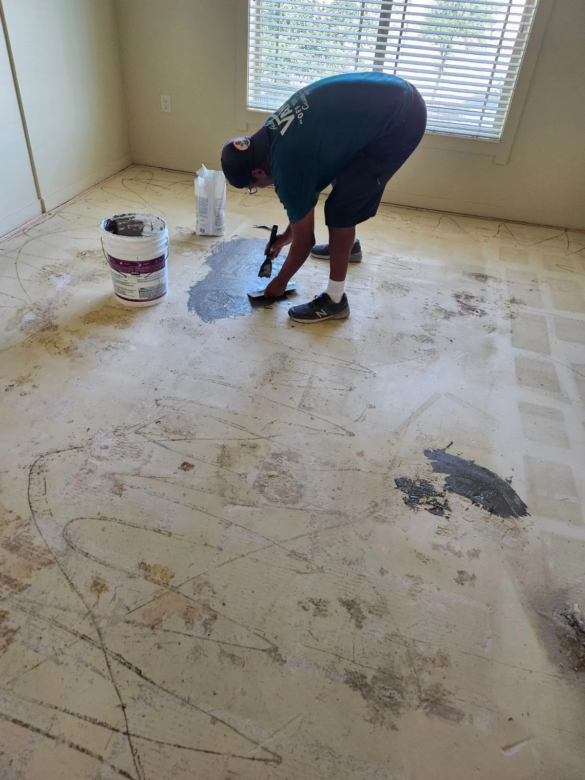 Bare concrete slab being prepped and patched after old tile removal by RDC Renovation in Phoenix AZ