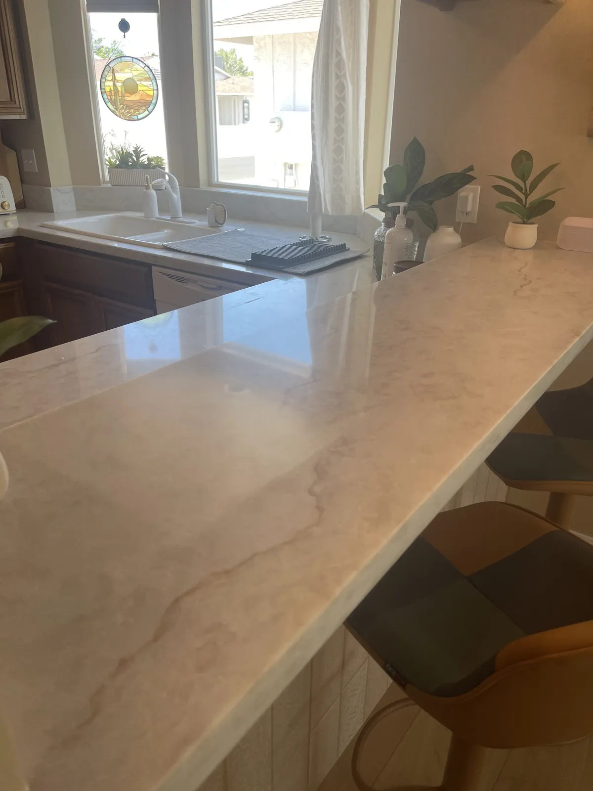 Cream stone countertop on a kitchen pass-through installed by RDC Renovation in Phoenix AZ