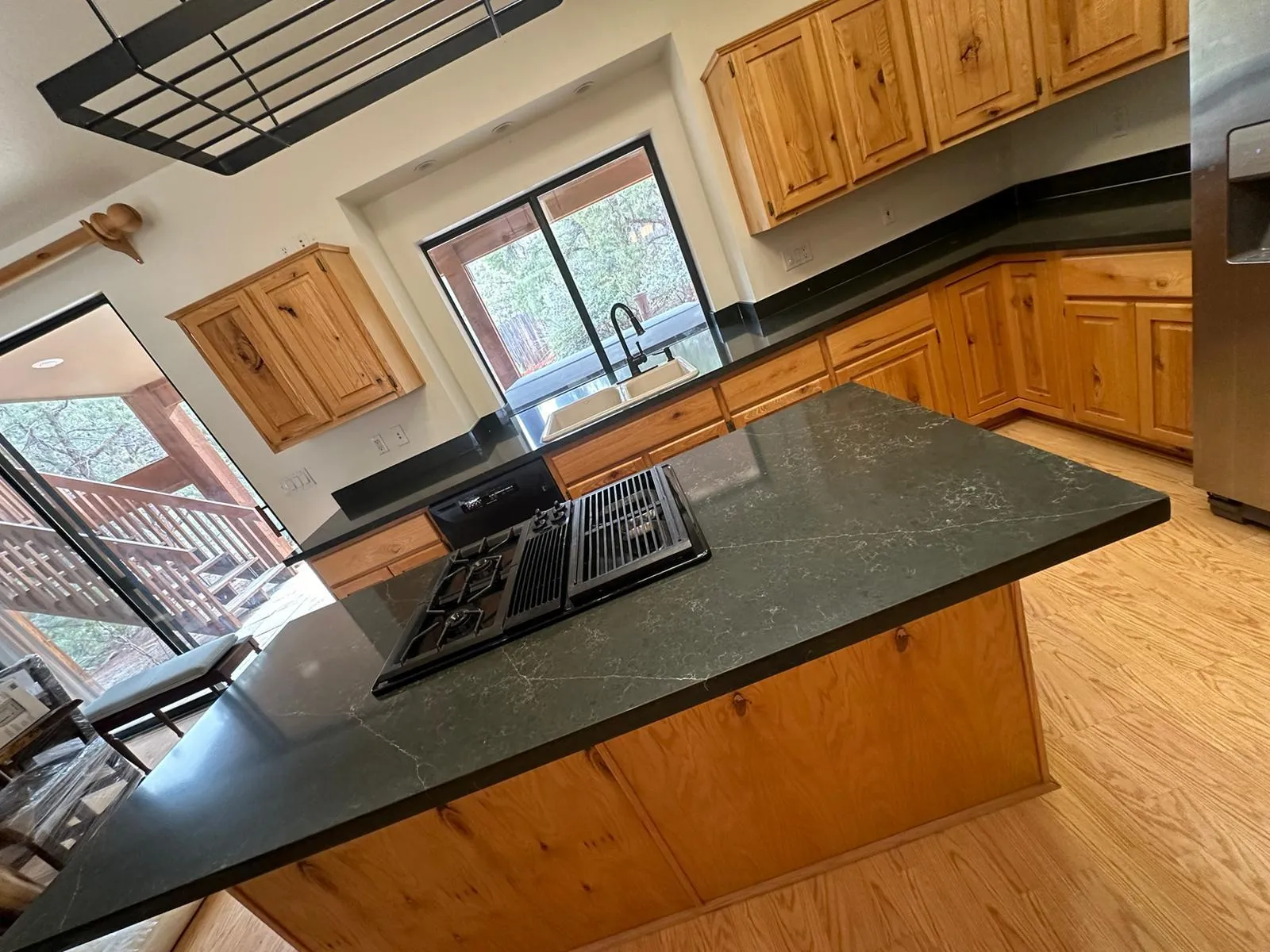 Dark granite countertops installed over existing oak cabinets in a Phoenix AZ kitchen by RDC Renovation