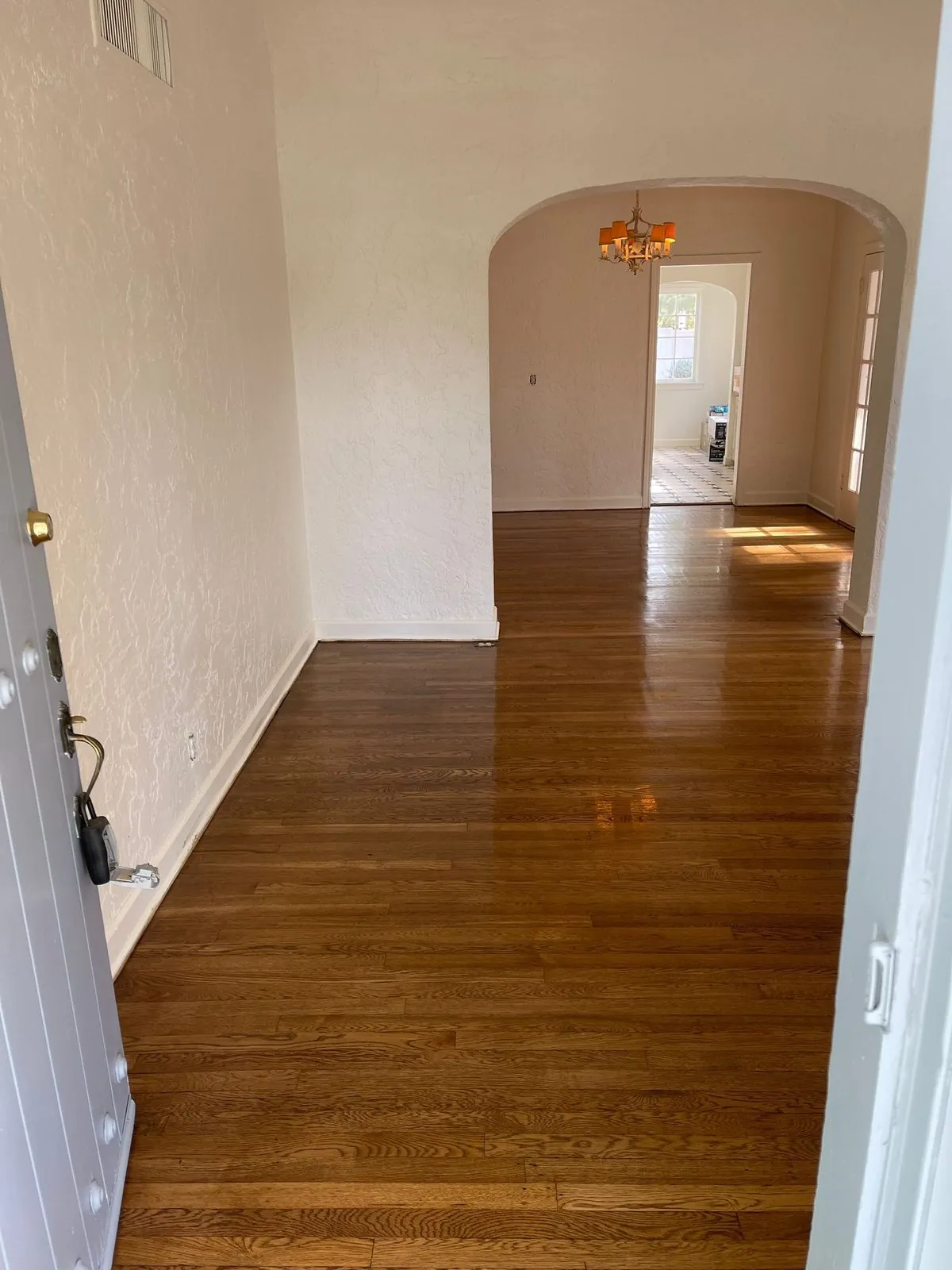 Dark hardwood flooring in Spanish style arched entry hallway Phoenix AZ