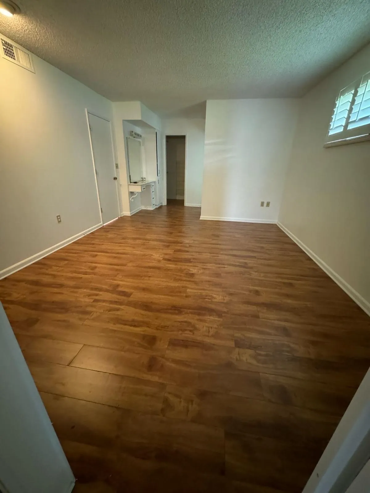 Dark hardwood flooring in an empty living room in Phoenix AZ installed by RDC Renovation