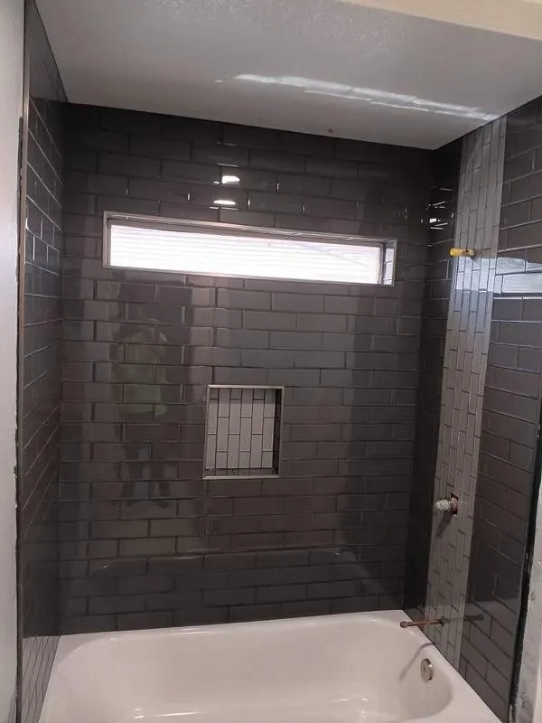 Dark subway tile tub and shower combo with tile niche Phoenix AZ
