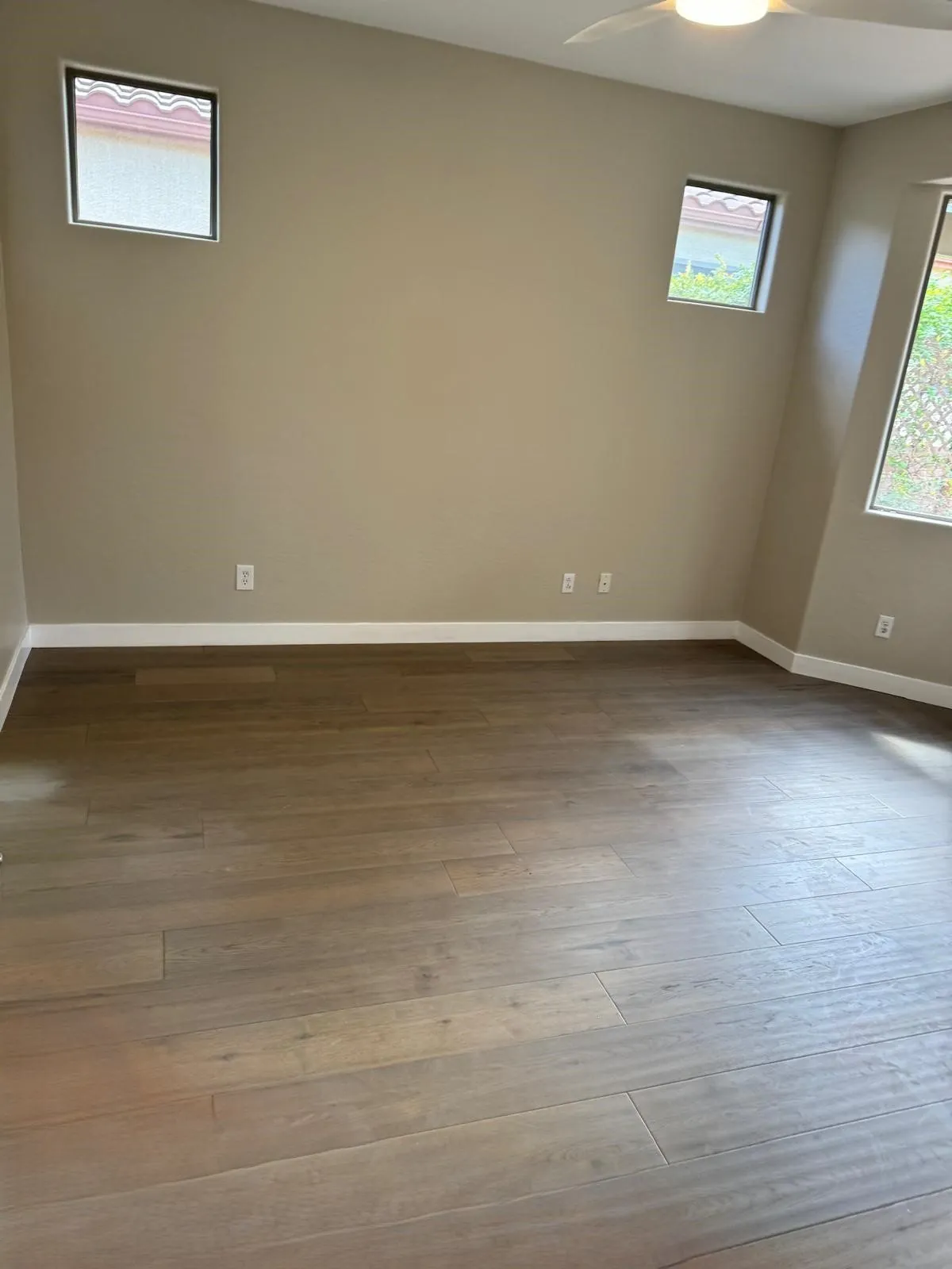 Dark wood look flooring installation in freshly renovated room Phoenix AZ