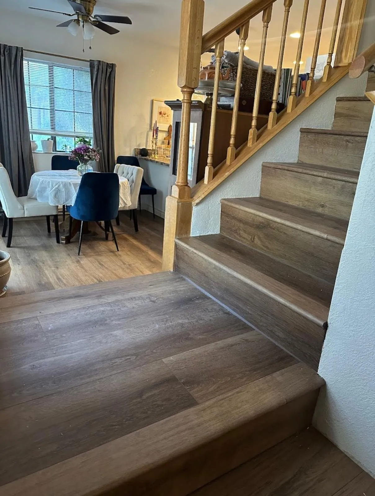 Wood look flooring in dining room and staircase with wood spindle railing Phoenix AZ