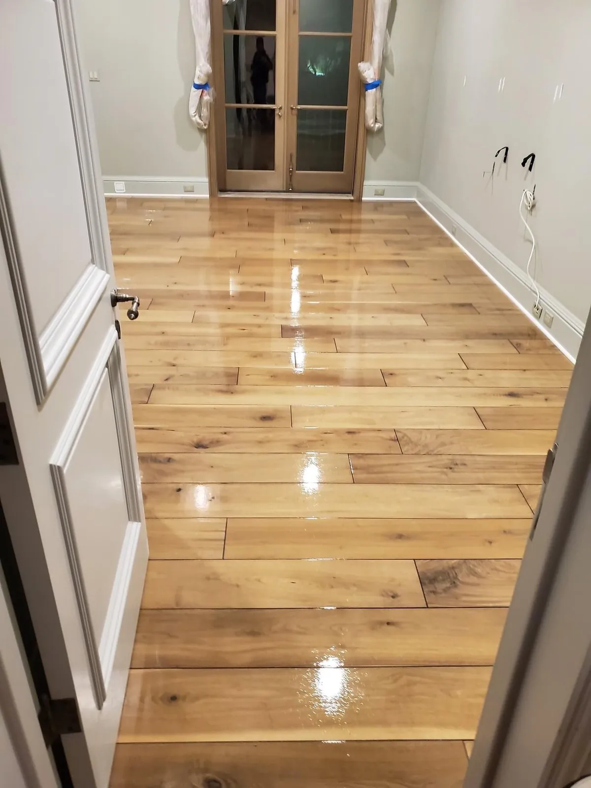 Glossy finished rustic hardwood flooring in hallway Phoenix AZ