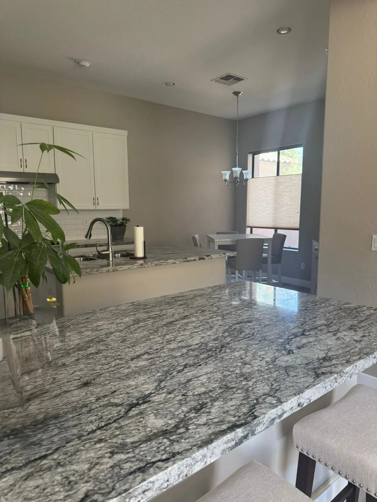 Granite breakfast bar countertop that RDC Renovation installed in an open kitchen in Mesa, AZ