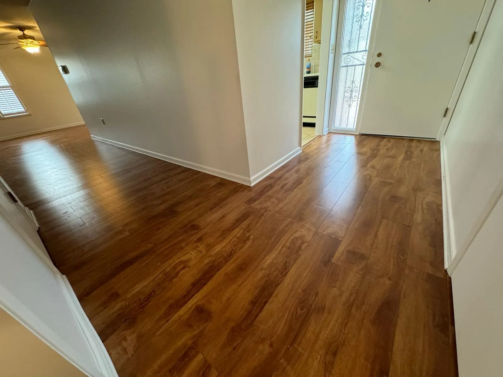 Wood-look laminate floor running from the front entry into the hallway of a Sun City, AZ home, installed by RDC
