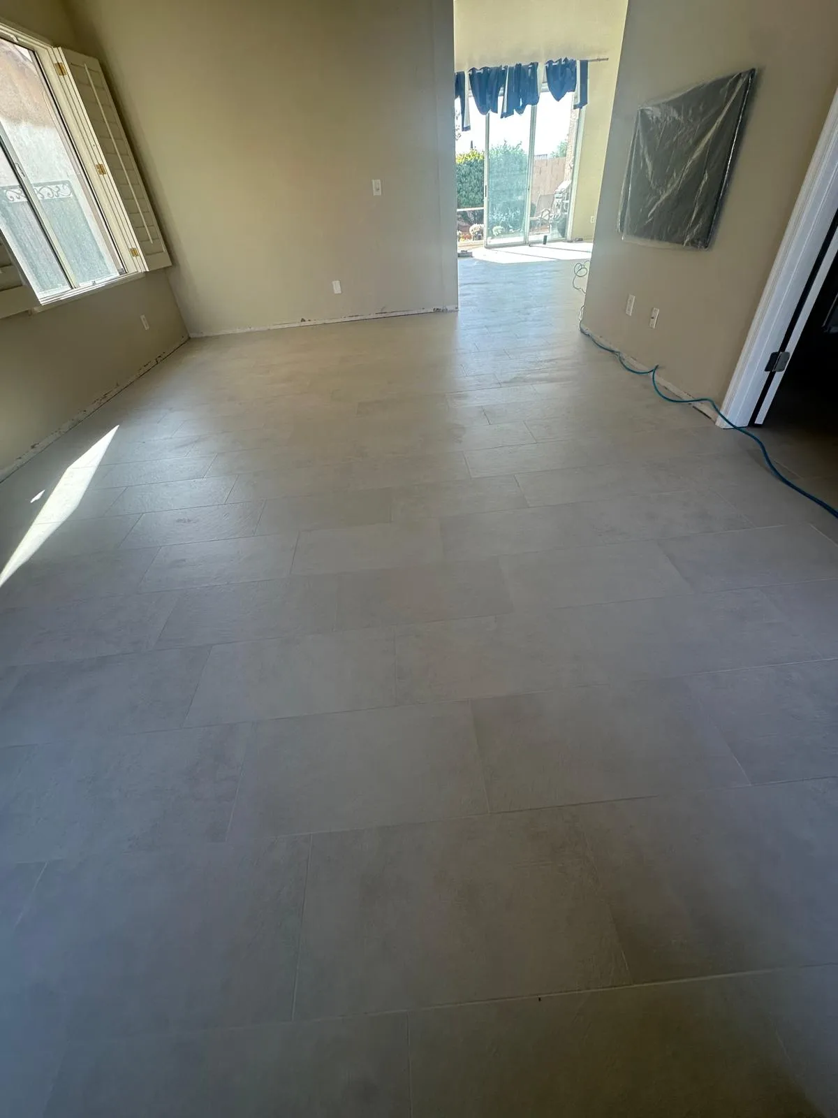 Large format tile flooring across a great room installed by RDC Renovation, serving Chandler AZ