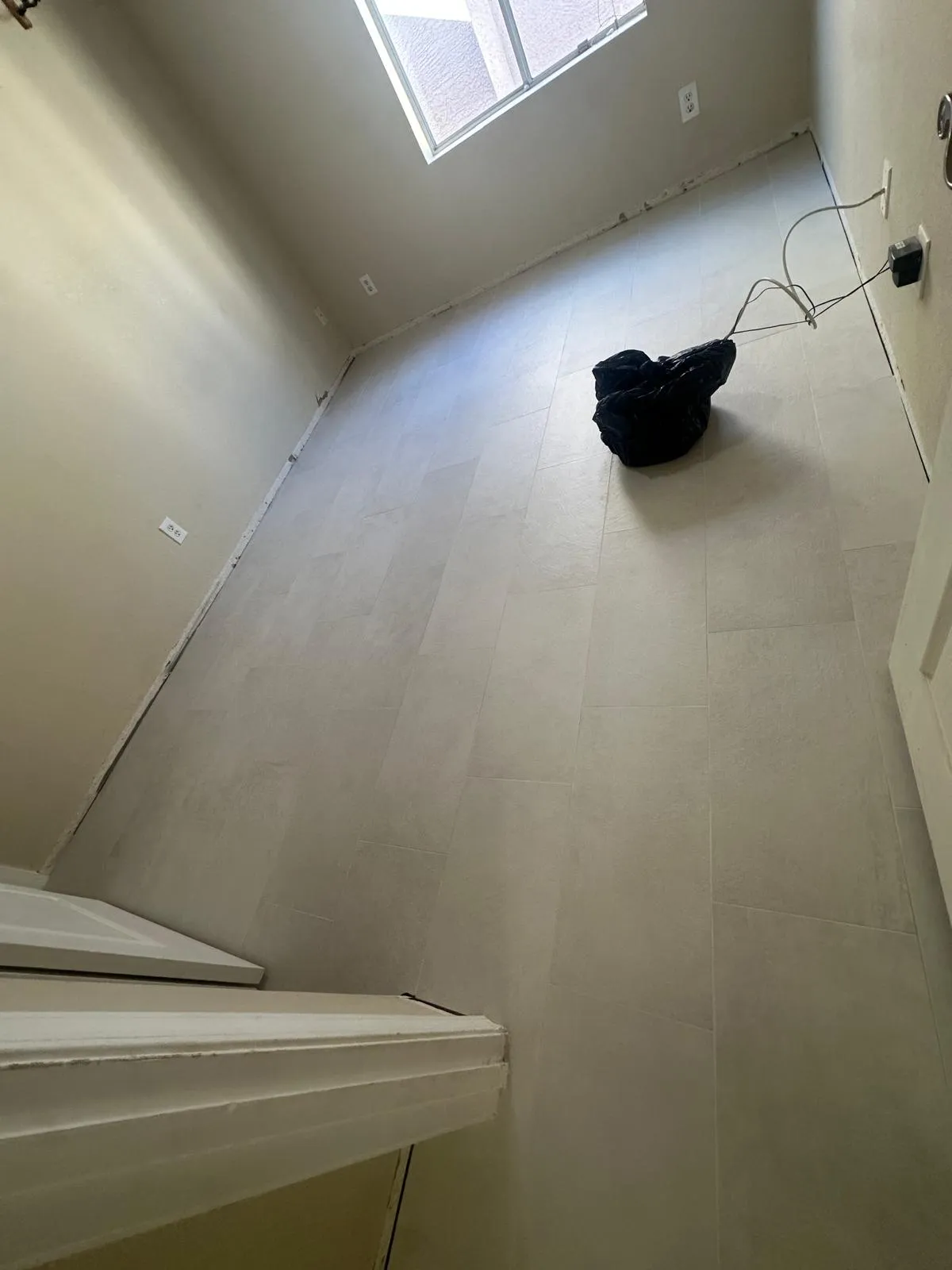Large format tile flooring at a stair landing installed by RDC Renovation, serving Sun City West AZ