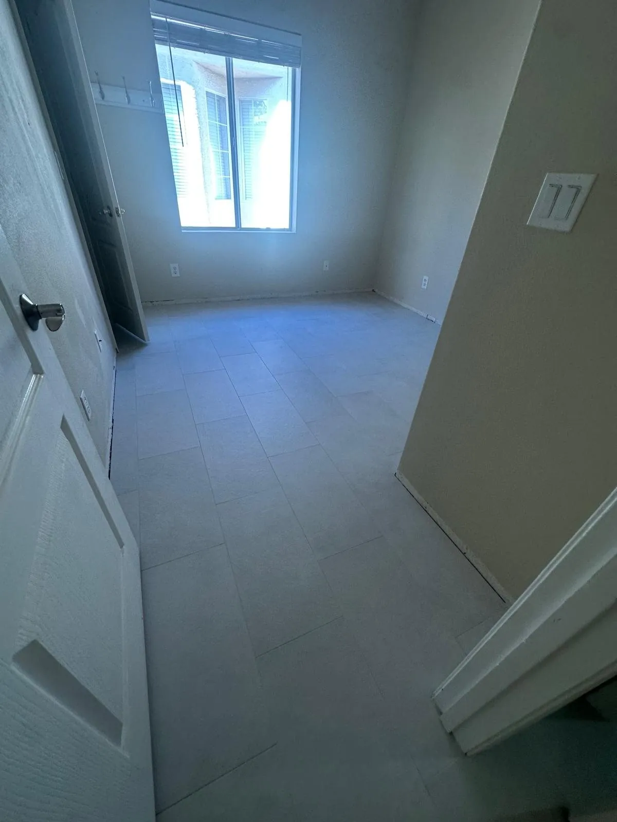 Light gray tile flooring installation in empty bedroom Phoenix AZ