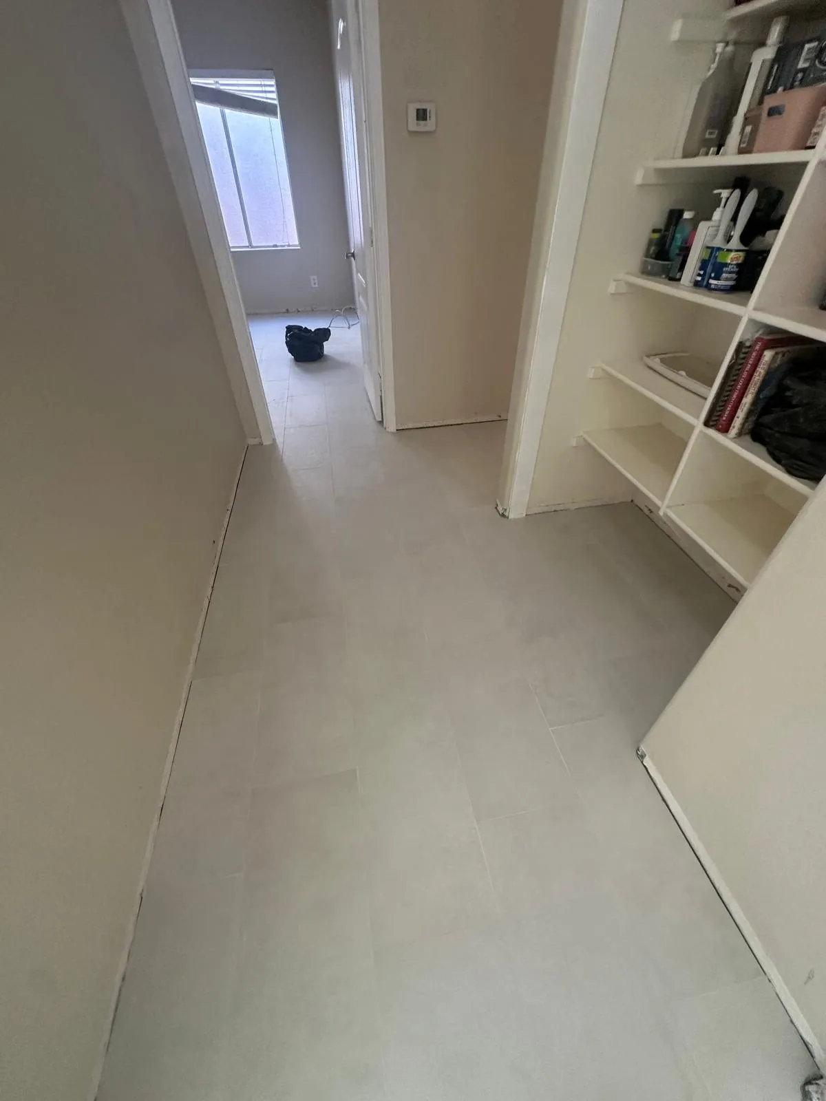 Light gray tile flooring installation in hallway and closet area Phoenix AZ