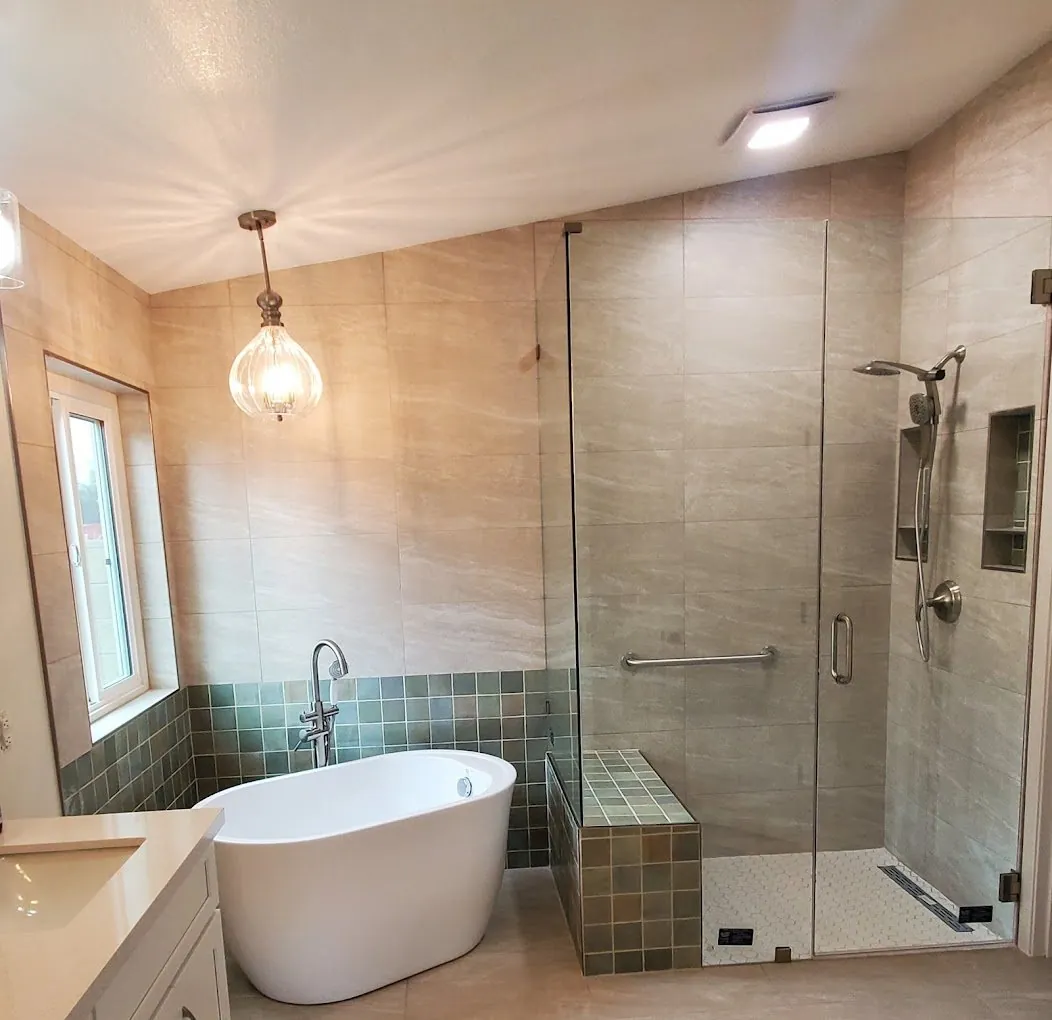 Luxury bathroom remodel with freestanding soaking tub green mosaic tile accent and glass shower Phoenix AZ