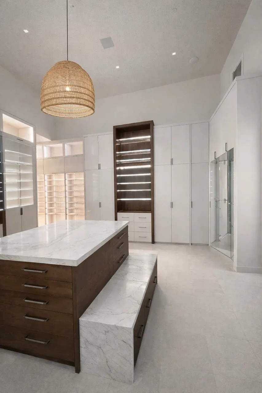 Luxury walk-in closet with marble look tile floor and quartz island countertop custom cabinetry Phoenix AZ