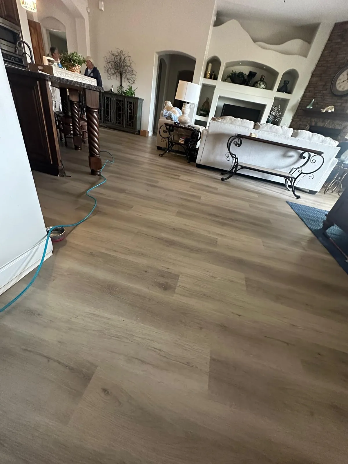 LVP flooring in a living room with a fireplace installed by RDC Renovation, serving New River AZ