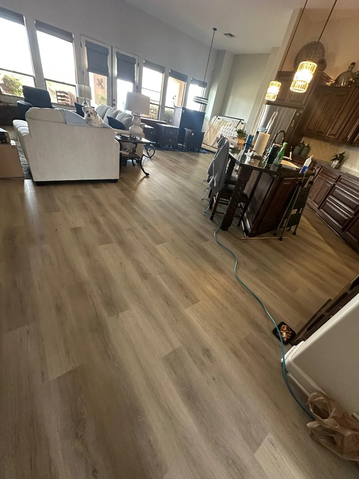 LVP flooring installed across an open living and dining area in an occupied home by RDC Renovation, serving Mesa AZ