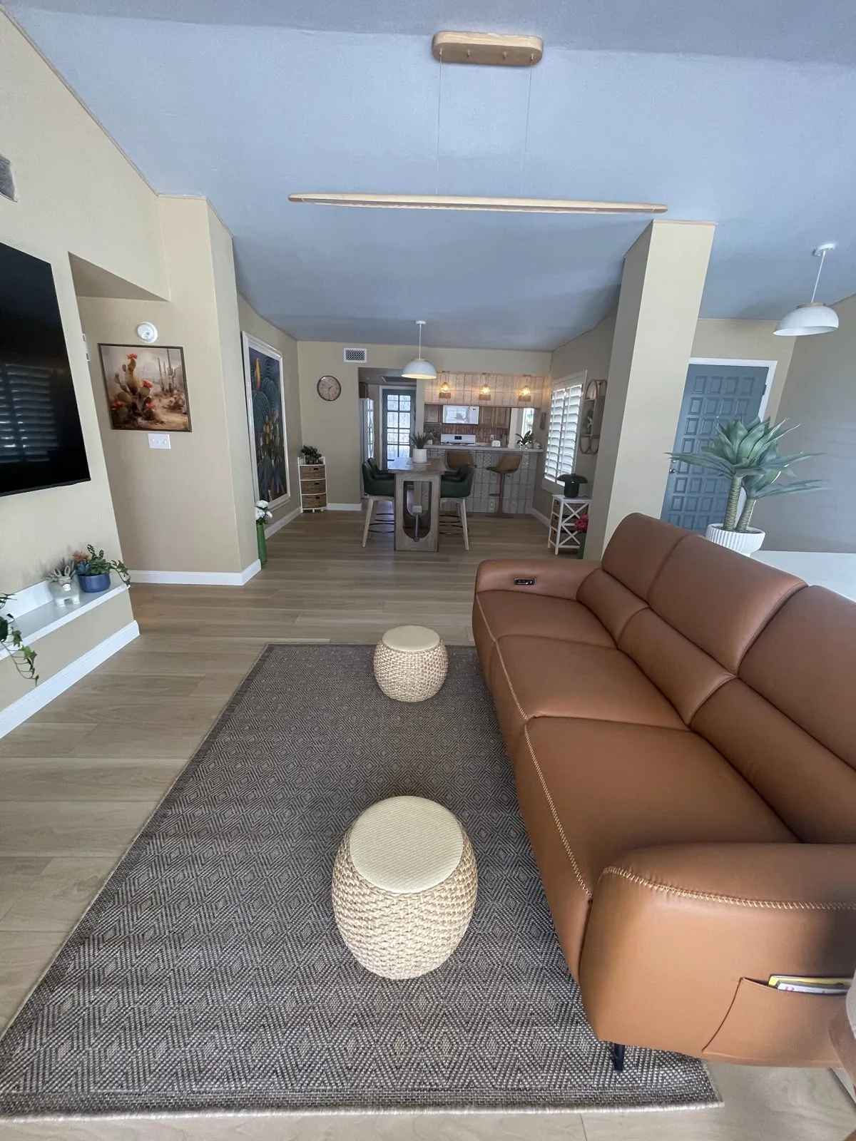 Open concept LVP flooring flowing through living room dining area and kitchen in full home remodel Phoenix AZ by RDC Renovation