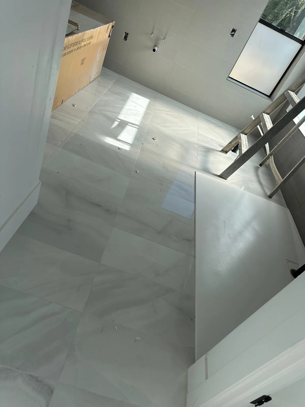 Polished large format tile flooring across an open plan Phoenix AZ home by RDC Renovation