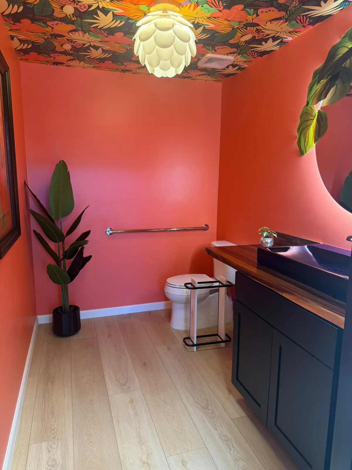 Powder room remodel with light plank flooring and a bold accent wall in Phoenix AZ by RDC Renovation