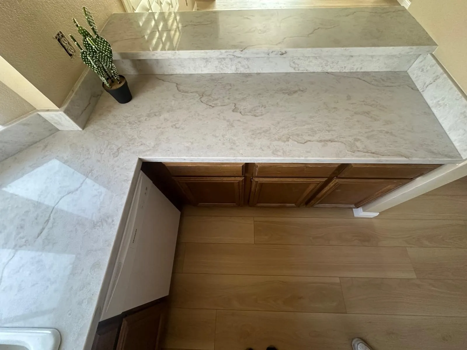 Quartz countertop with matching full height quartz backsplash and wood cabinets kitchen Phoenix AZ