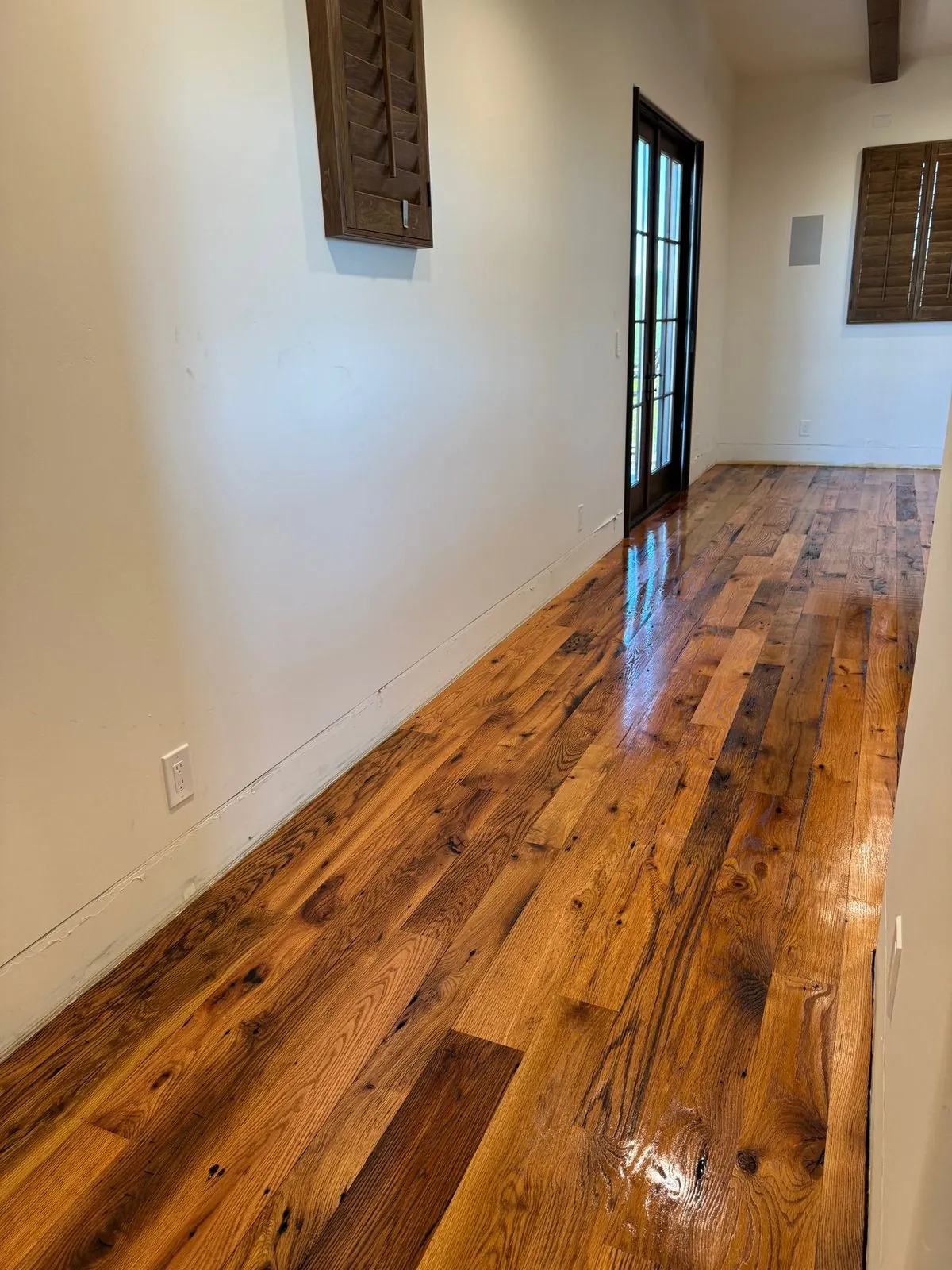 Reclaimed look rustic hardwood flooring with visible knots and glossy finish Phoenix AZ