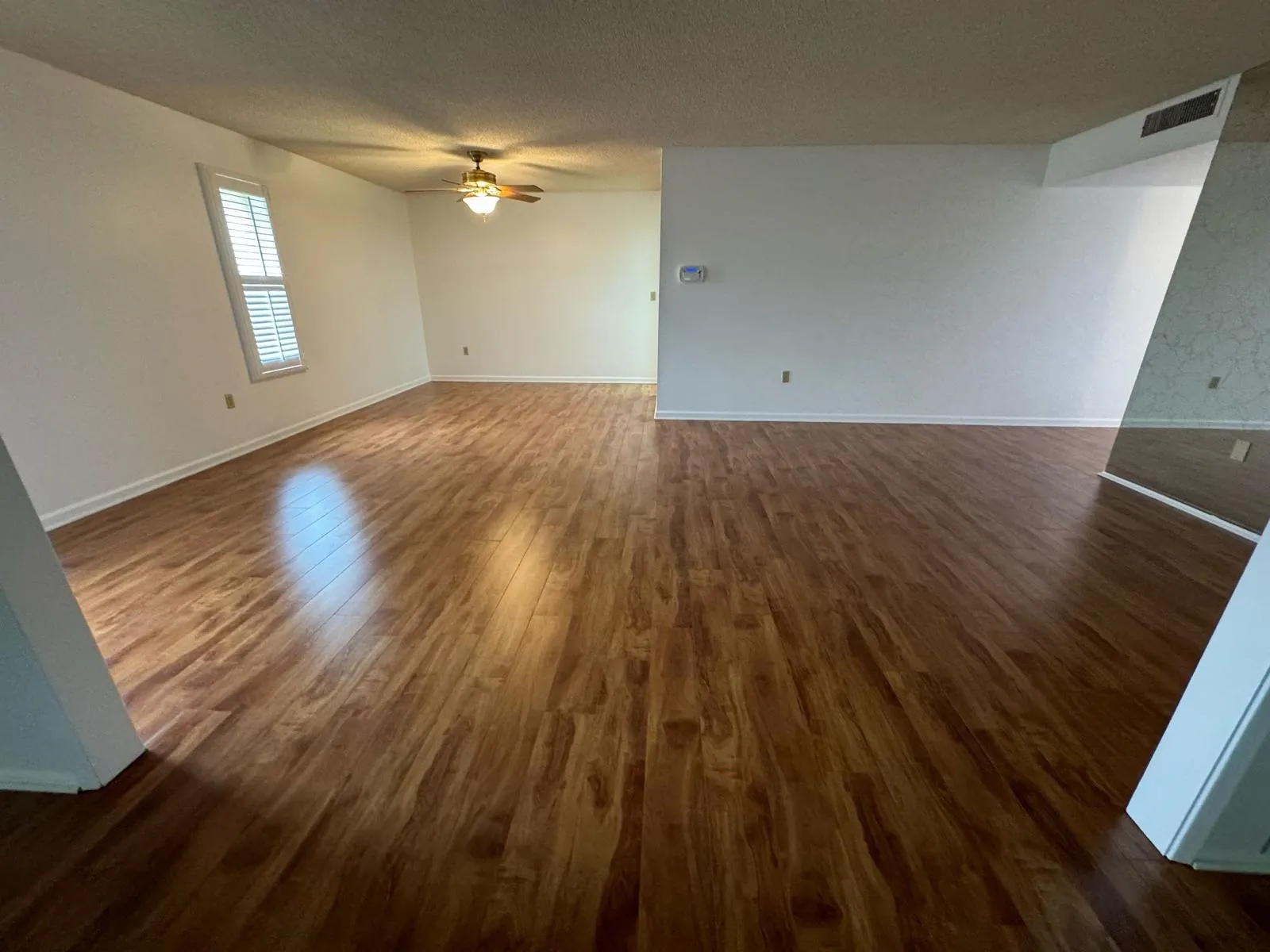 Refinished dark hardwood flooring in an open living room by RDC Renovation, serving Surprise AZ