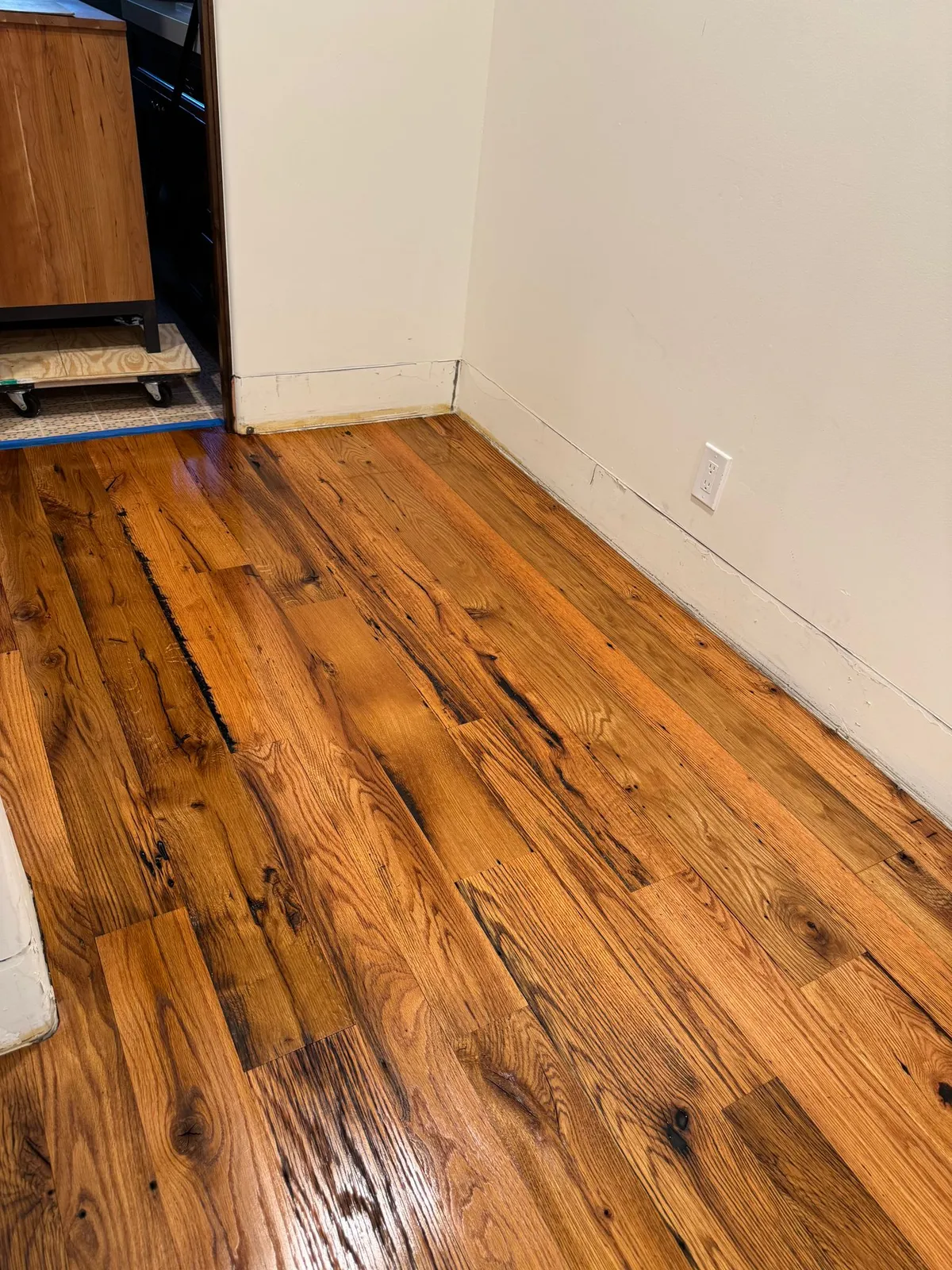 Rustic-grade hardwood floor at a kitchen doorway, sanded, stained and refinished by RDC in Fountain Hills, AZ
