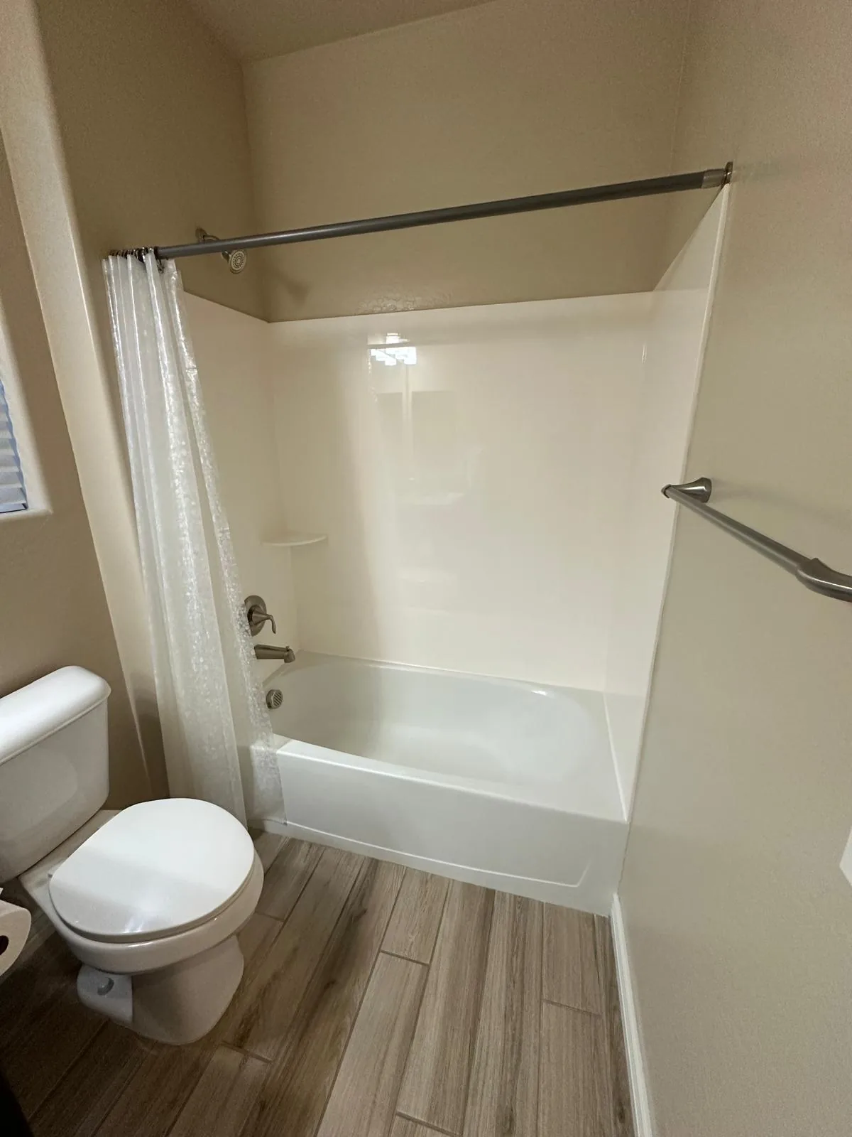 Phoenix, AZ bathroom before its tub-to-shower conversion: an old bathtub with a one-piece surround