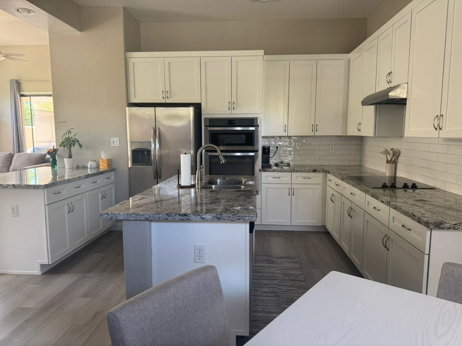 White cabinet kitchen with granite countertops and an island remodeled by RDC Renovation in Phoenix AZ