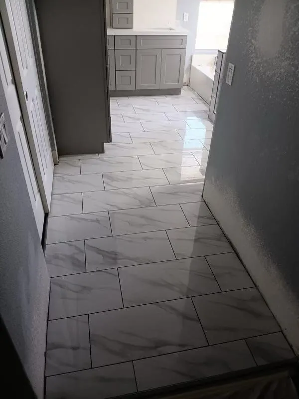 White marble look large format tile floor in bathroom hallway Phoenix AZ