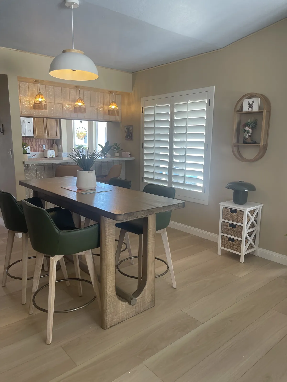 White oak LVP flooring in a dining area with a kitchen pass-through by RDC Renovation, serving Happy Valley AZ