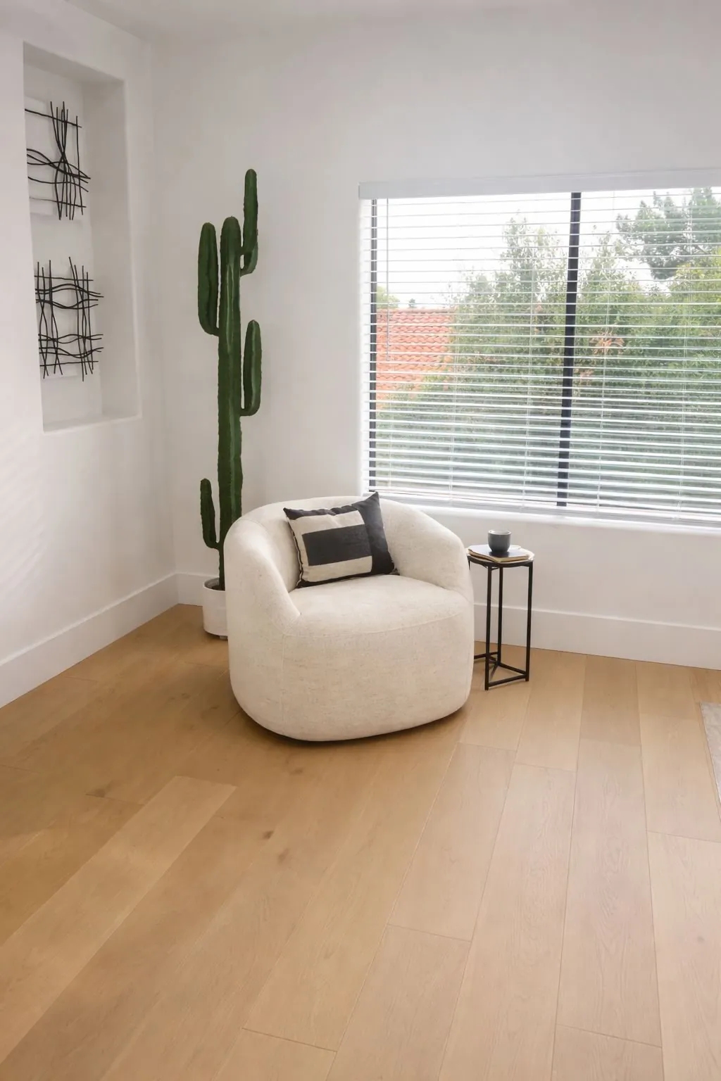 White oak LVP flooring installation in bright living room with reading nook Phoenix AZ by RDC Renovation
