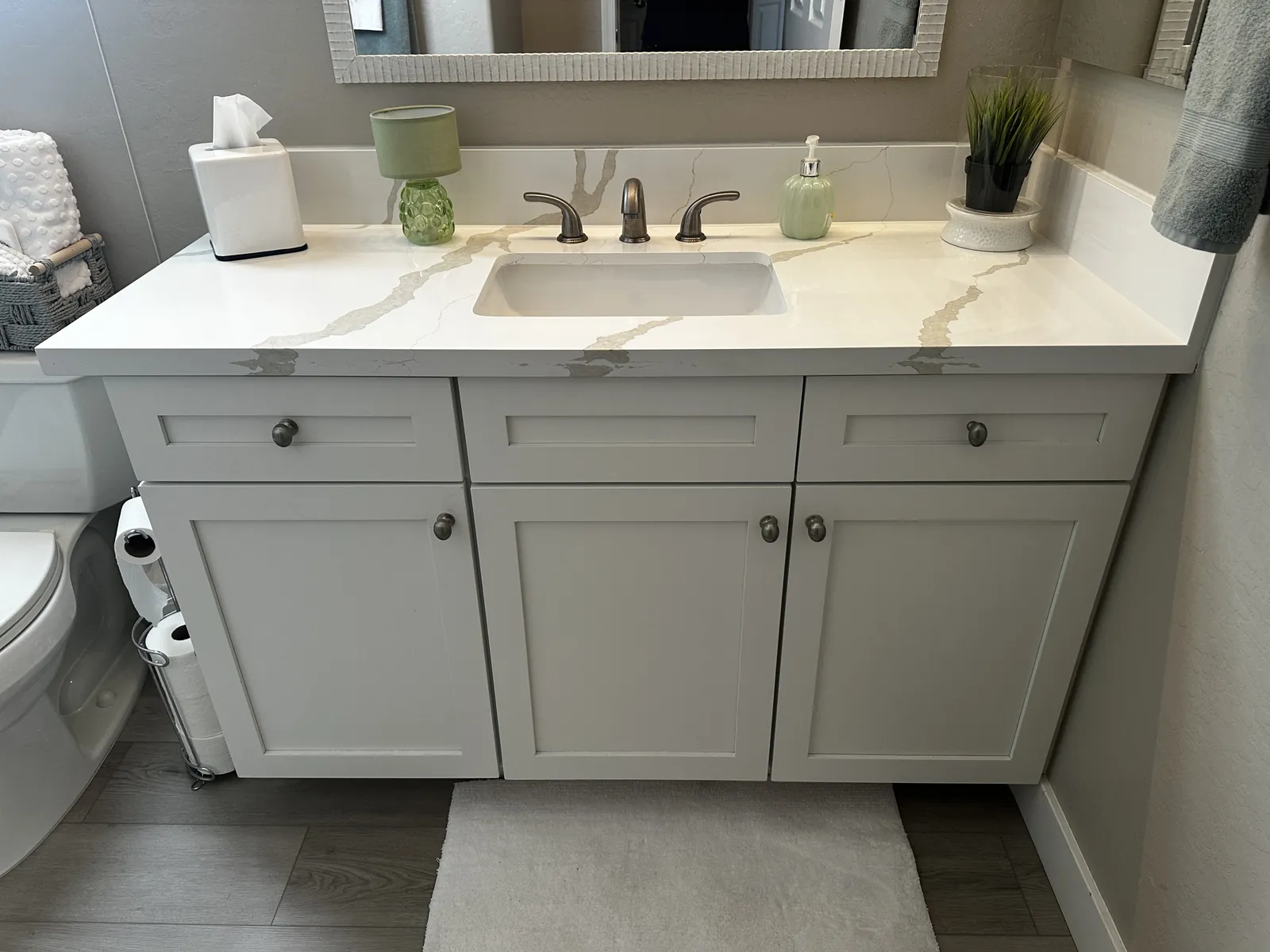 White quartz vanity top with an undermount sink on the same cabinet in a Mesa, AZ bathroom, by RDC Renovation