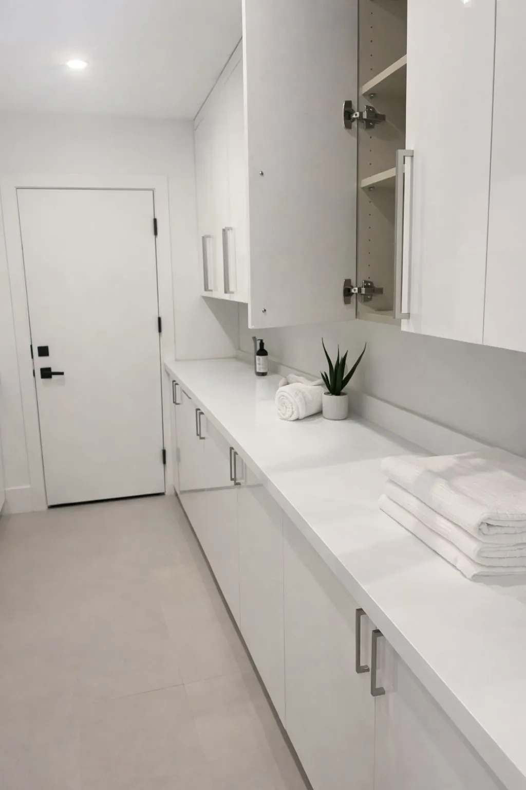 White quartz countertop and custom white cabinetry in laundry pantry room Phoenix AZ by RDC Renovation