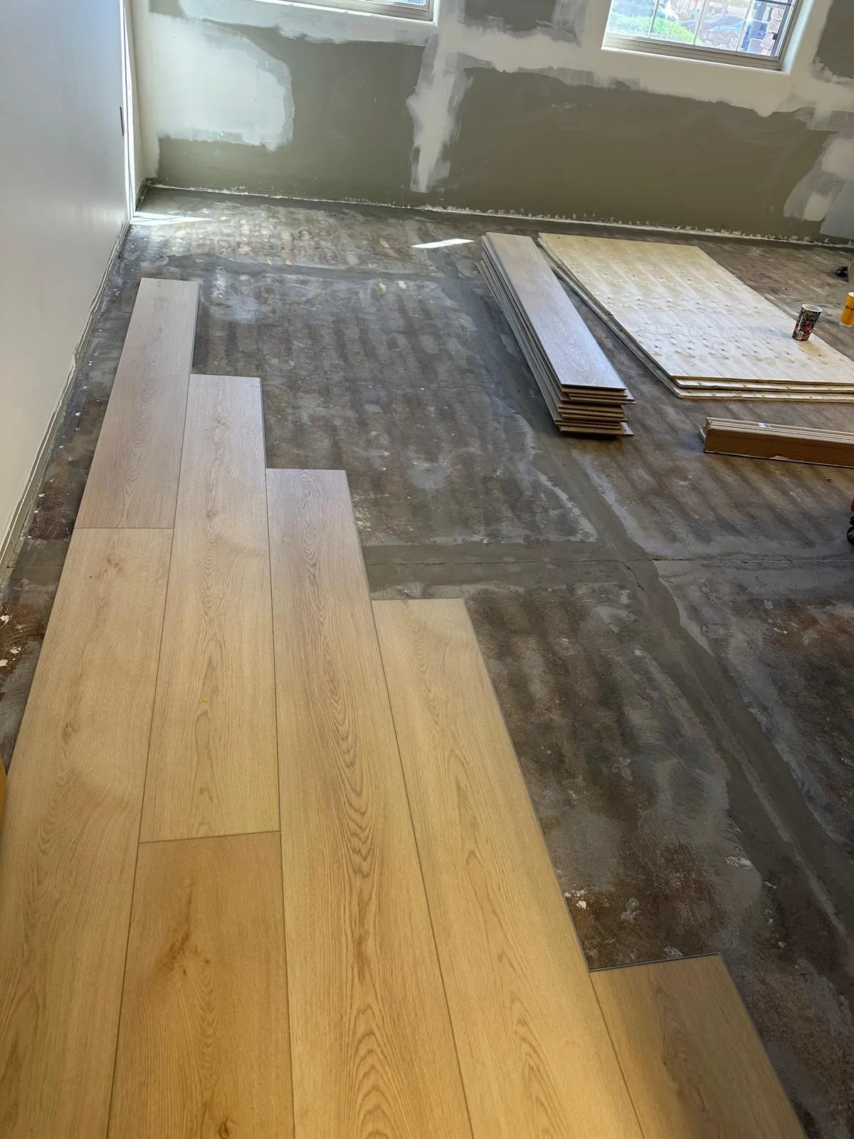 Wide plank flooring being installed over a prepared subfloor by RDC Renovation in Phoenix AZ