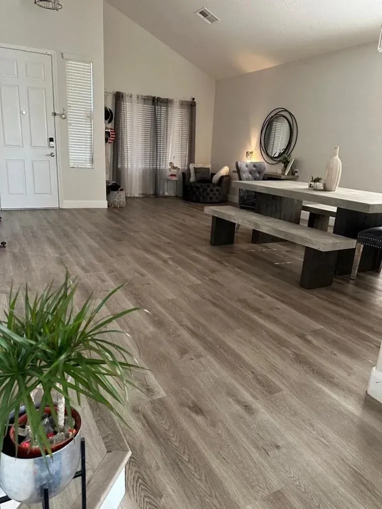 Wood look plank flooring flowing through an entryway into a living room in Phoenix AZ by RDC Renovation