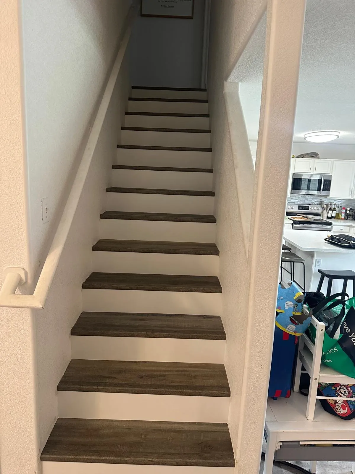 New wood look LVP stair treads with white risers Phoenix AZ