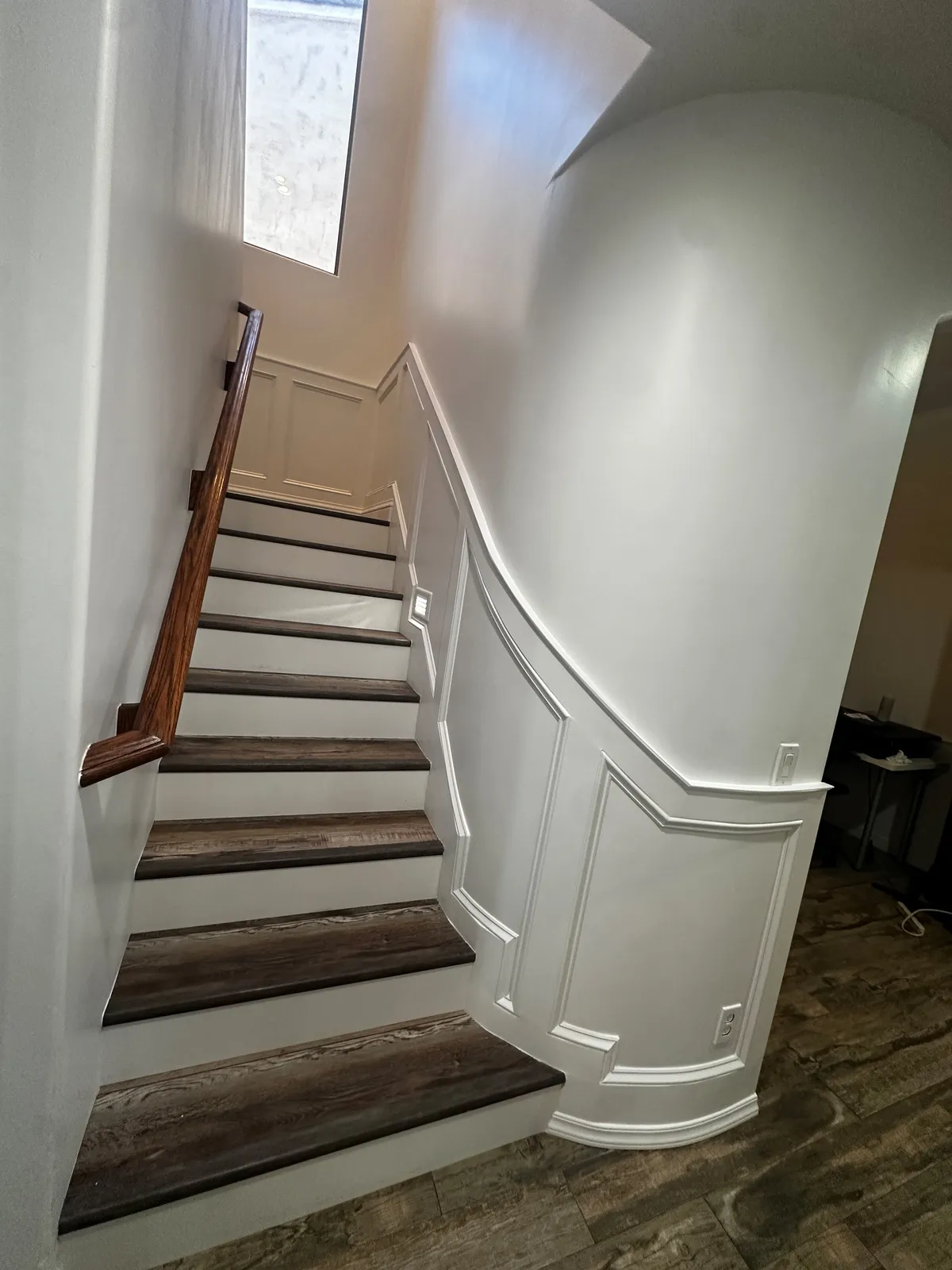 Wood tread staircase against a curved wall in a custom Phoenix AZ home by RDC Renovation